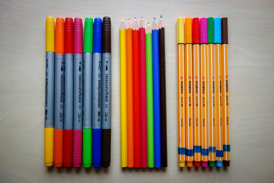 pens, colored pencils, felt tip pens, wooden pegs, colorful