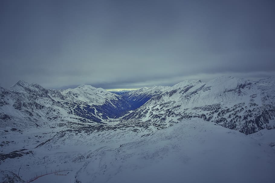 Mountain Covered in Snow Under White Cloudy Sky during Daytime HD wallpaper