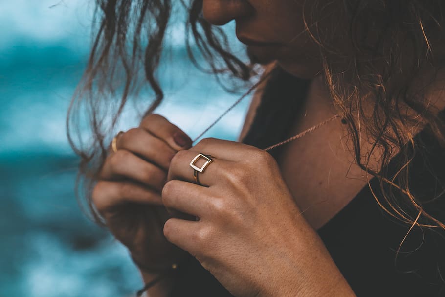 woman holding her gold-colored necklace, ring, hand, person, necklack HD wallpaper
