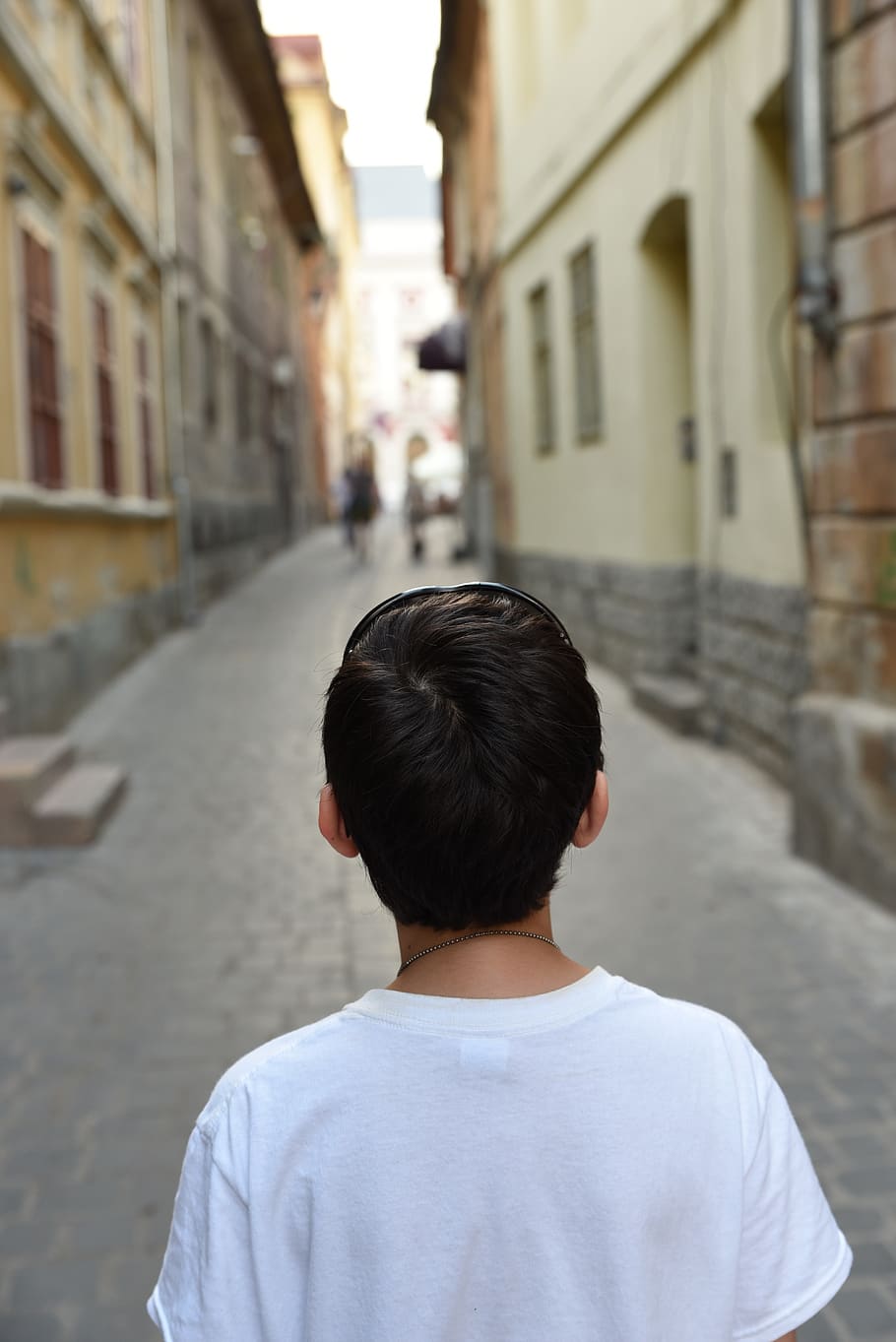 teenager, boy, back, old street, white shirt, architecture