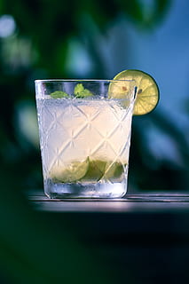 clear liquid inside clear drinking glass, lemonade, beverage HD wallpaper