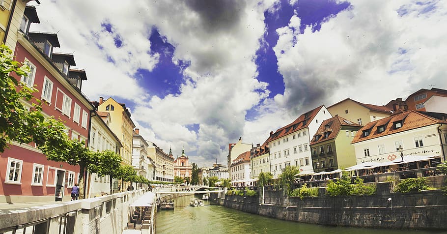 River Near Building Under White Grey and Blue Sky during Dayime HD wallpaper