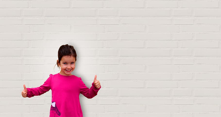 Cute Little Girl Showing Thumbs Up - Background with Copyspace