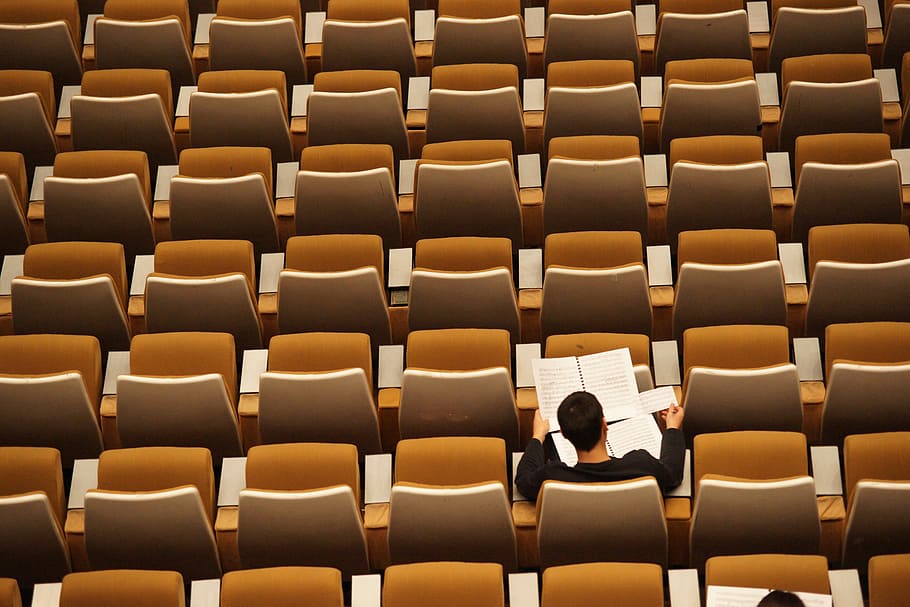 men's black long-sleeved top, seat, person, notes, paper, page HD wallpaper
