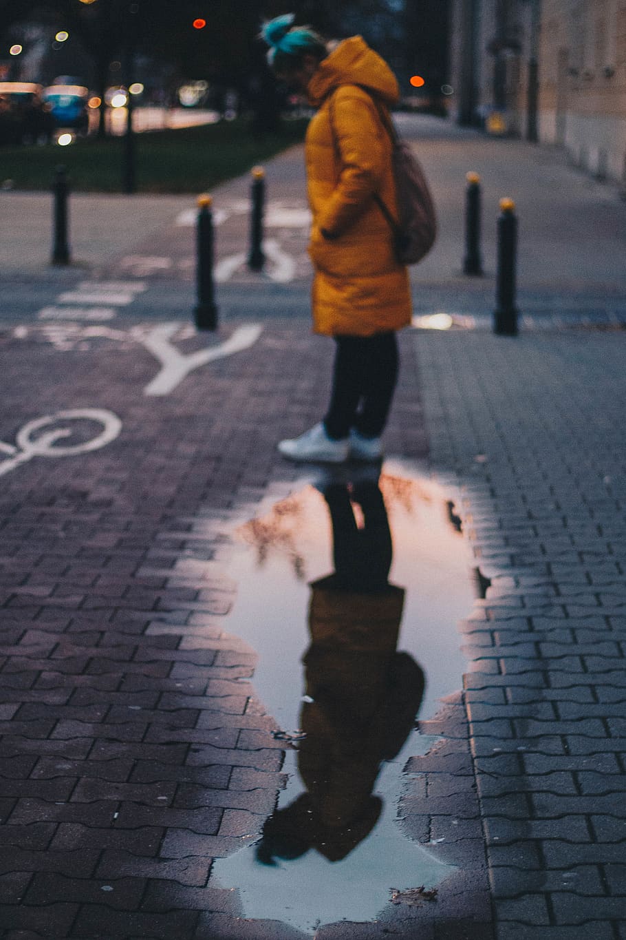 woman standing beside wet road, puddle, human, person, pedestrian