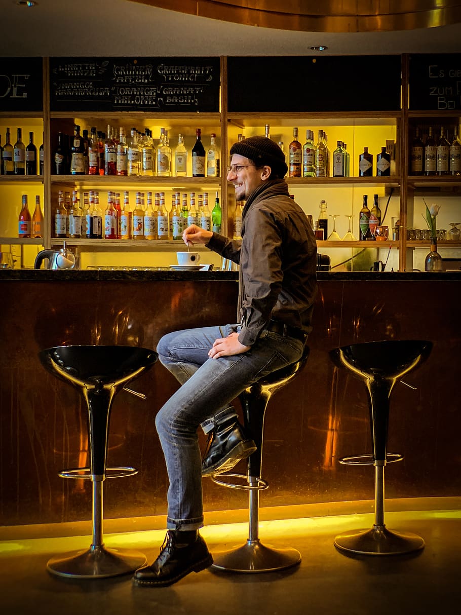 man sitting on hydraulic barstool, pub, bar counter, person, human
