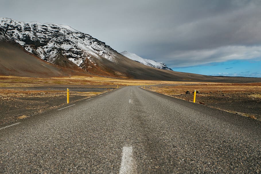 gray asphalt road under cloudy sky, mountain, direction, snow HD wallpaper