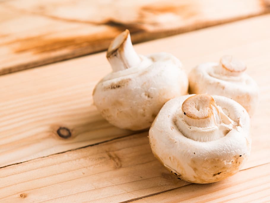 Three White Mushrooms on Beige Wooden Table, board, close -up HD wallpaper