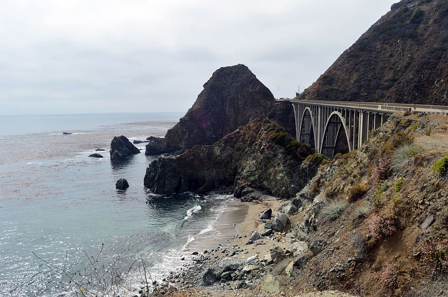 concrete bridge between mountain and sea, coast, ocean, beach HD wallpaper