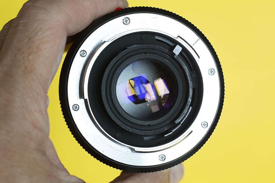 person holding gray camera lens, electronics, erlangen, germany HD wallpaper