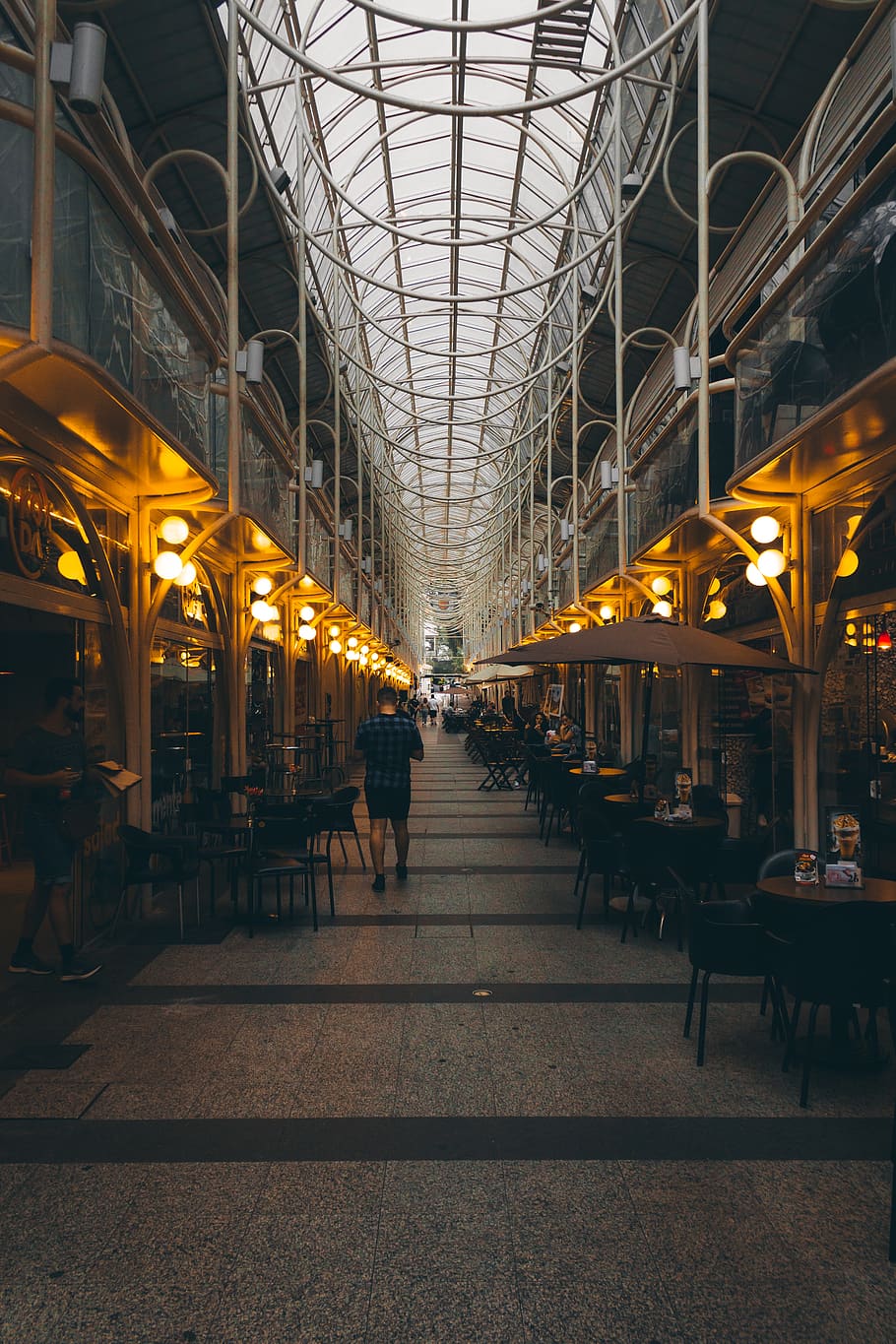 Man Walking Near Tables, architecture, building, chairs, commerce HD wallpaper