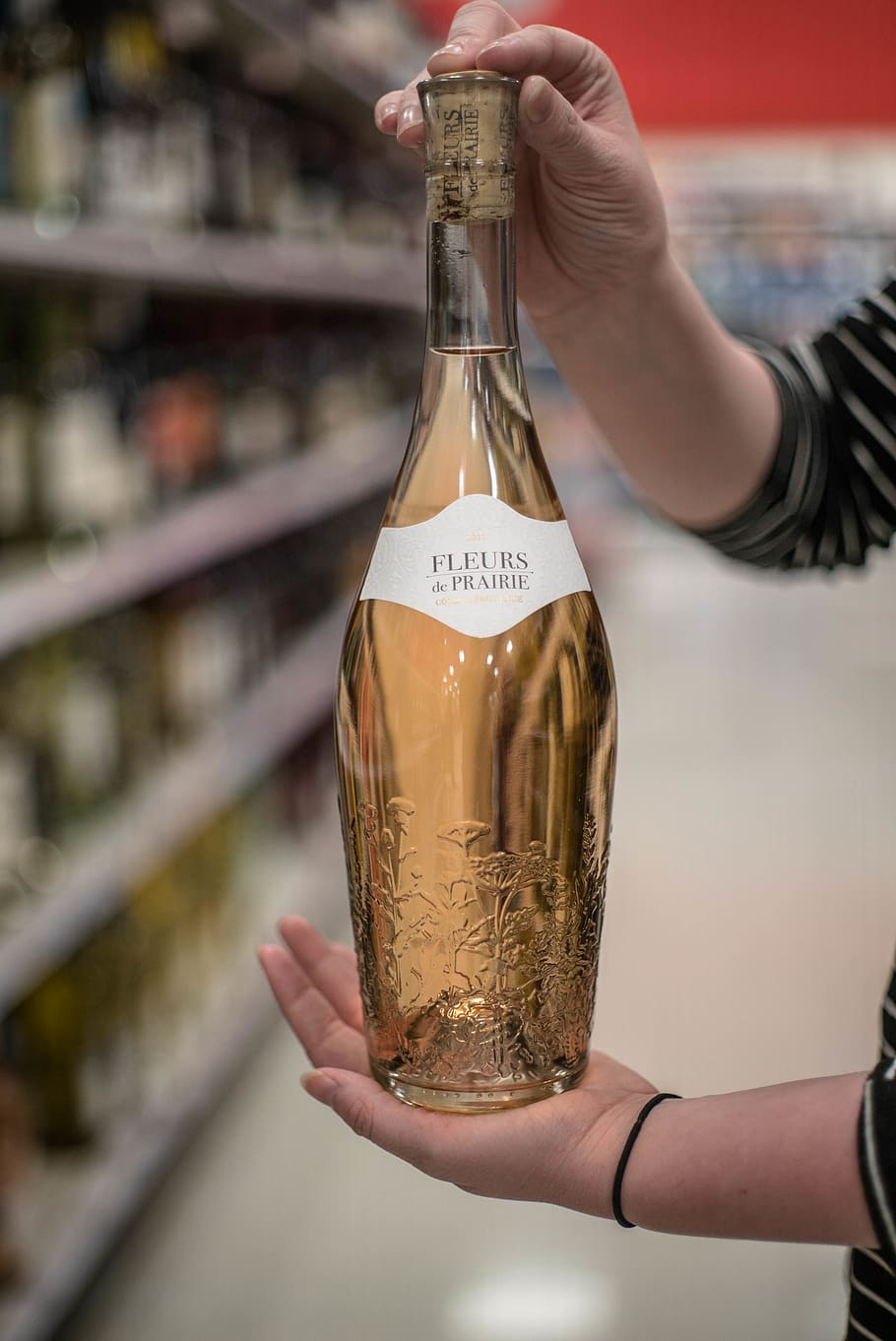 person holding Fleurs bottle inside store, one person, container HD wallpaper