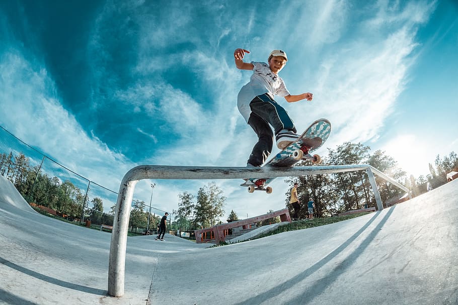 man riding skateboard doing grind rail during daytime, person, HD wallpaper