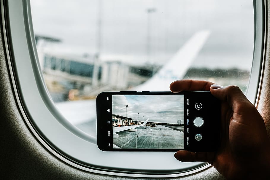 black iPhone capturing plane wing, window, glass - material, wireless technology HD wallpaper