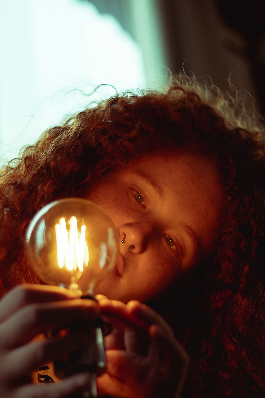 Woman Holding Turned On Bulb, curly, female, light, light bulb HD wallpaper