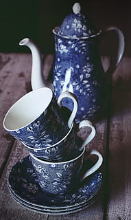 Blue and White Floral Ceramic Teacup and Teapot on Brown Wooden Table HD wallpaper