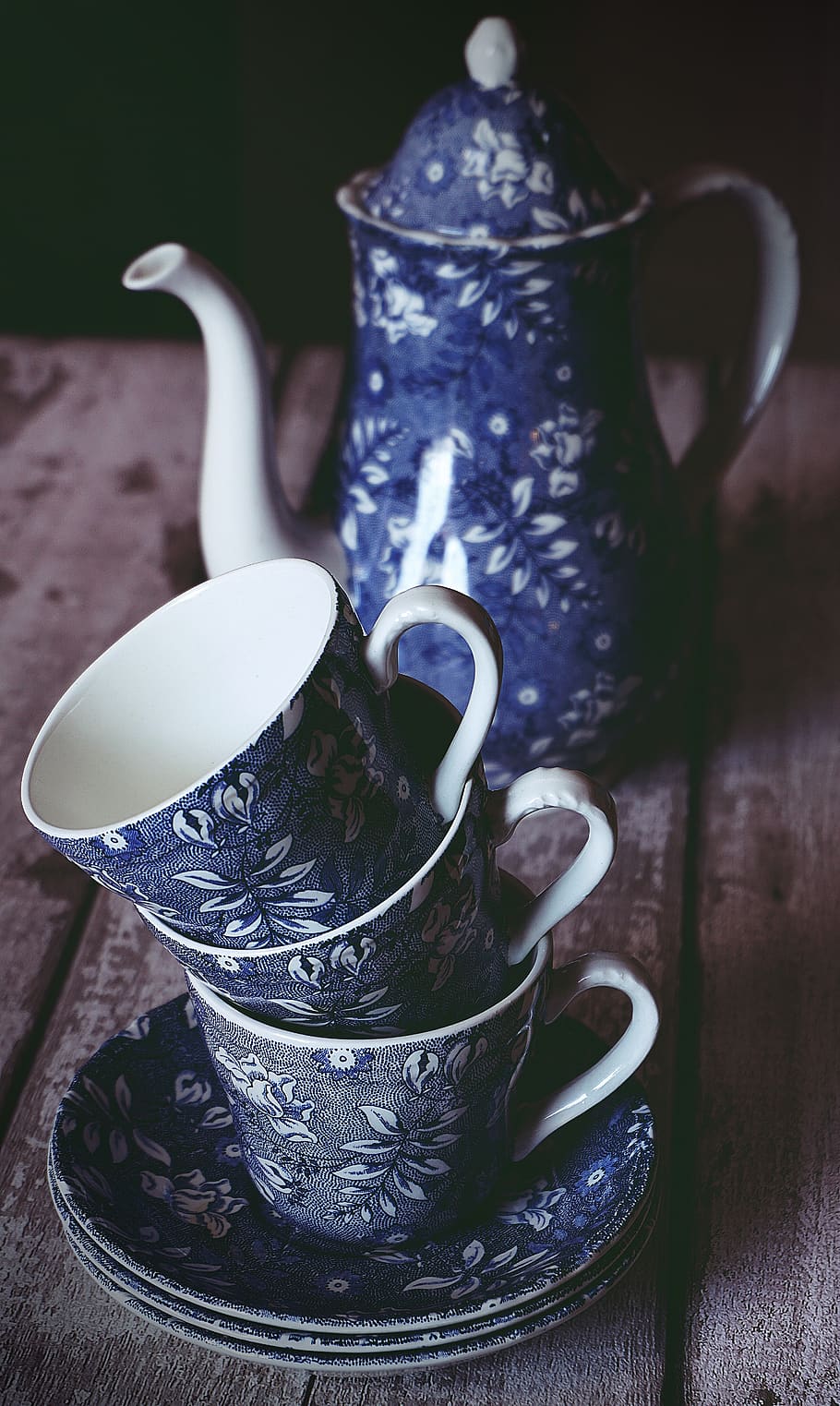 Blue and White Floral Ceramic Teacup and Teapot on Brown Wooden Table HD wallpaper