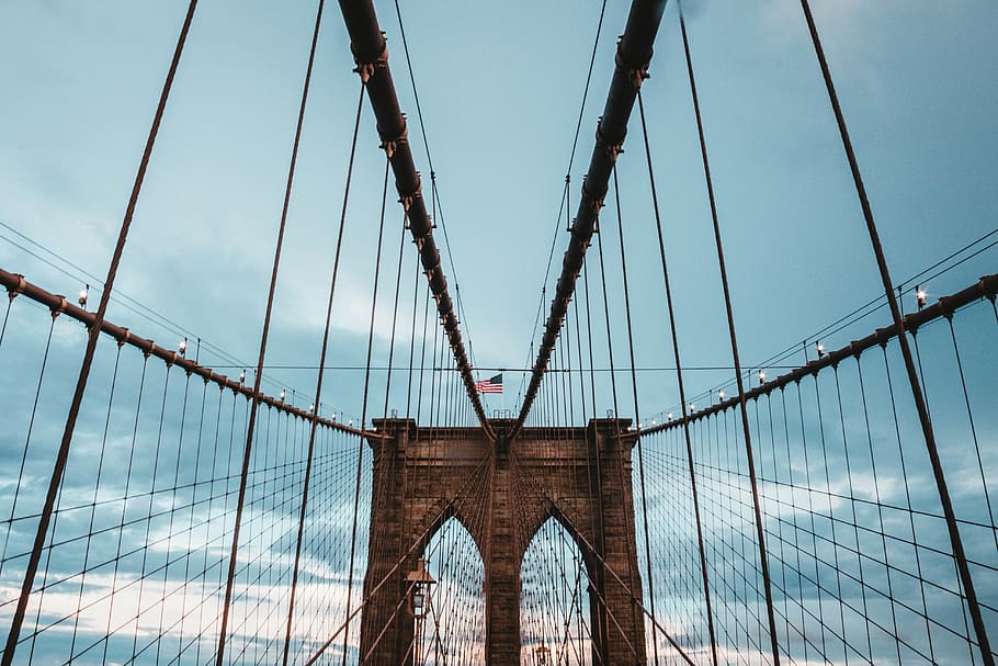 low angle photo of brown concrete suspension bridge under blue sky at daytime, HD wallpaper