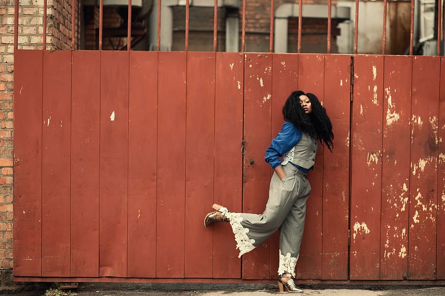 Woman Wearing Grey Jumpsuit Standing Beside Brown Metal Gate HD wallpaper