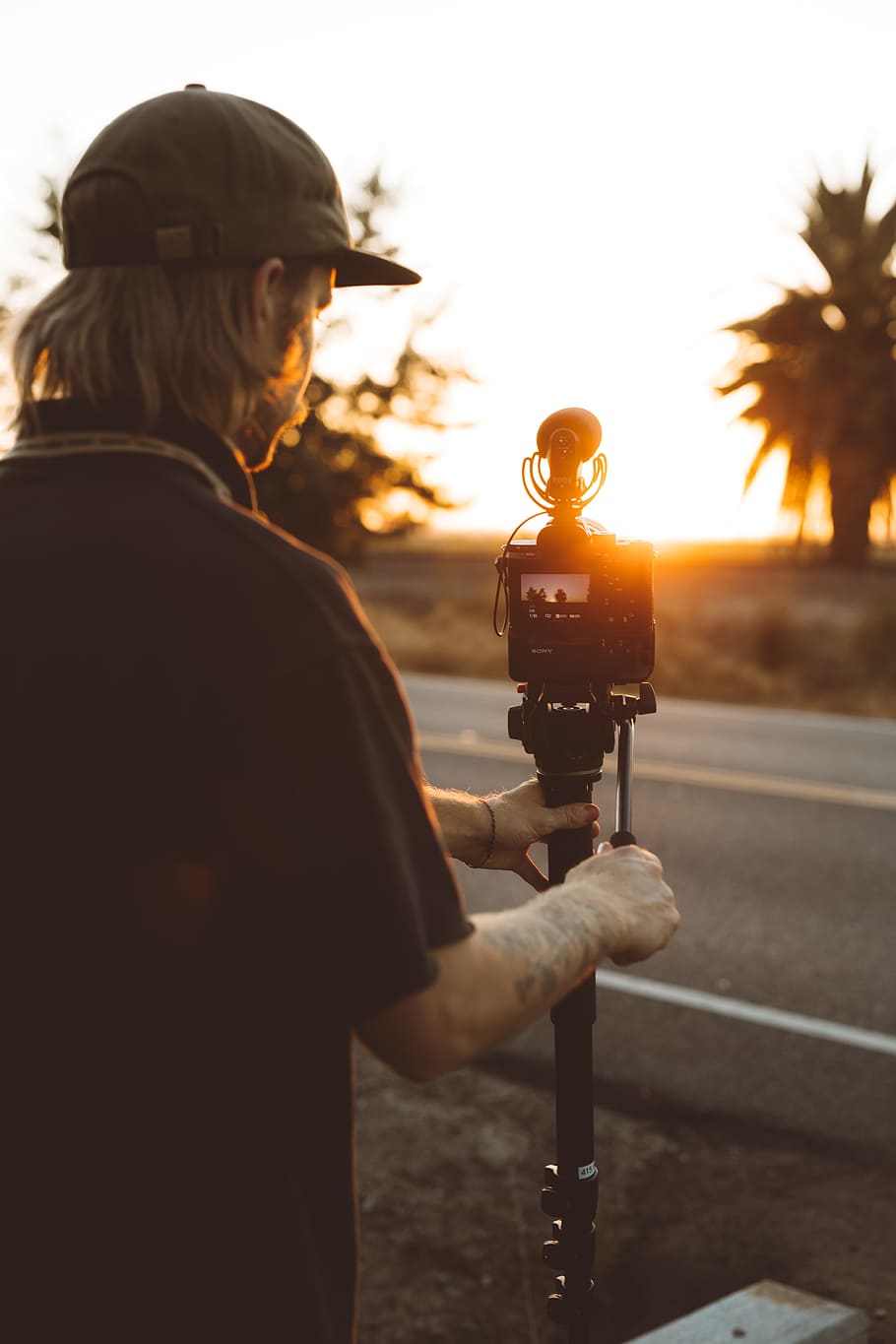 man standing near road and camera, male, sunset, sunrise, video HD wallpaper