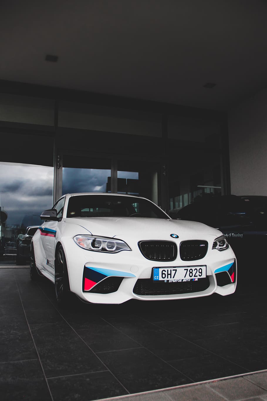 white BMW M-Sport coupe parked inside building, automobile, car