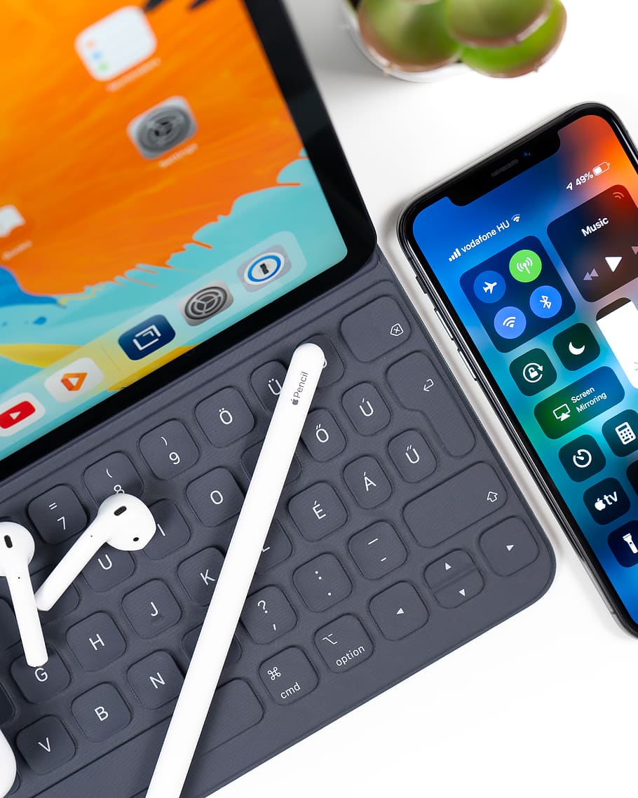 iPad with keyboard, white stylus, white AirPods; and an iphone on table, HD wallpaper