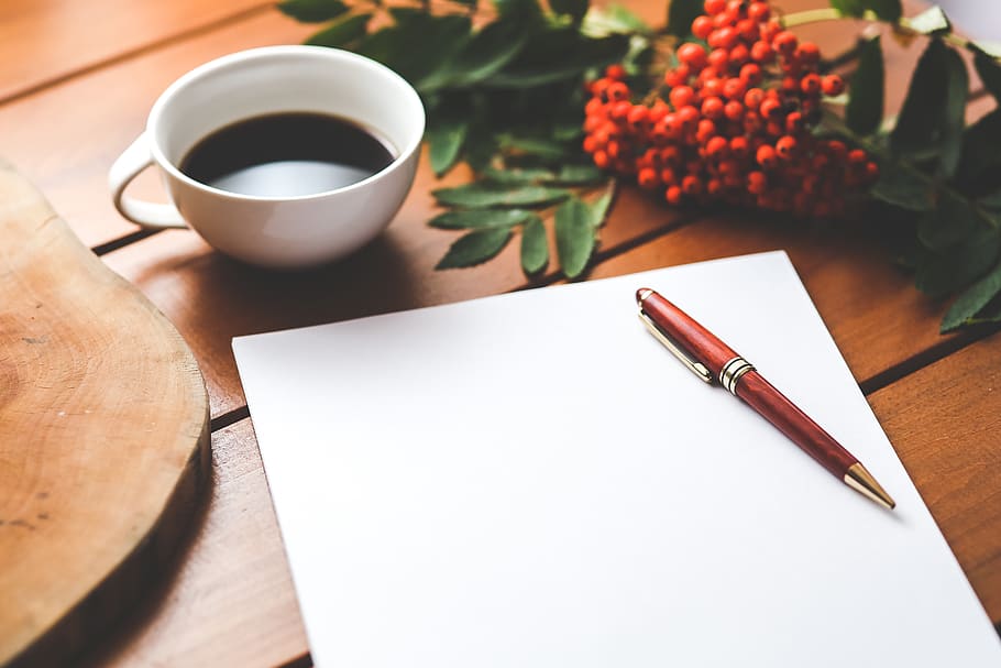 Blank paper with pen and coffee cup on wood table, brainstorming HD wallpaper