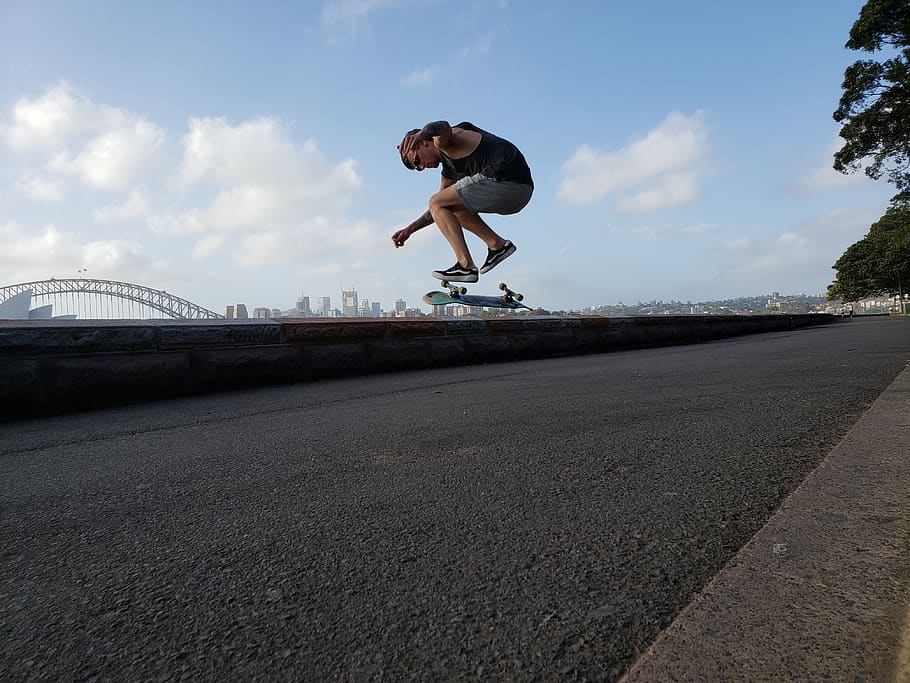 Man Skateboarding, action, asphalt, clouds, low angle shot, motion HD wallpaper