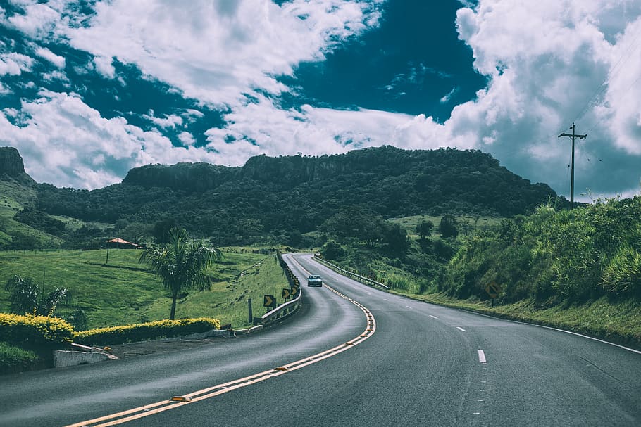 Green Vehicle on Concrete Road, car, clouds, fields, grass, mountains HD wallpaper