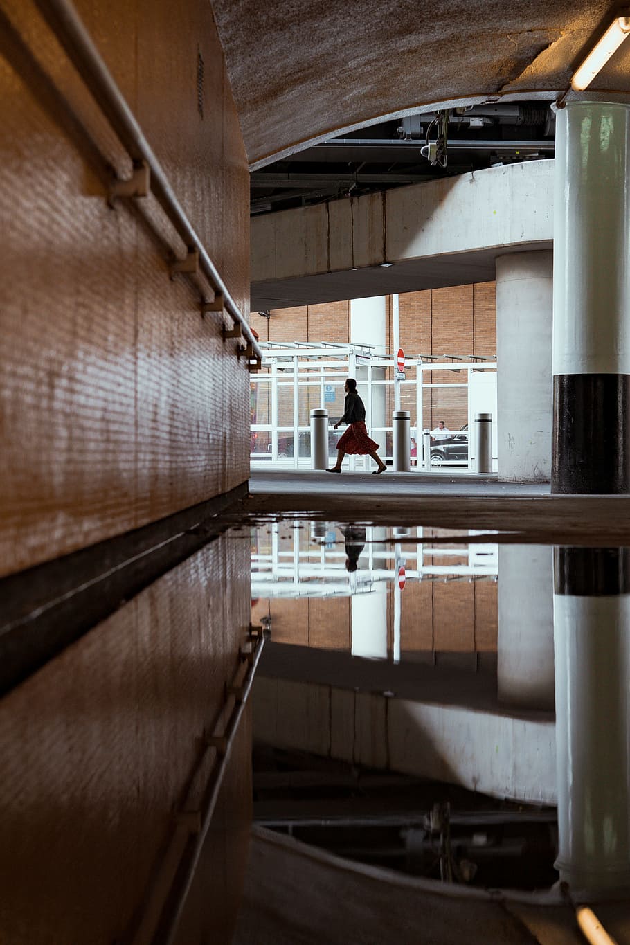 person walking inside concrete building, wall, water, underneath HD wallpaper