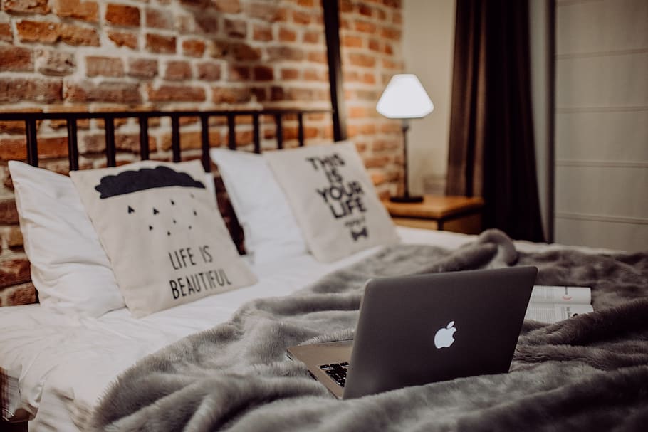 Enjoying evening with a Macbook in a nice bed, home, loft, brick wall HD wallpaper