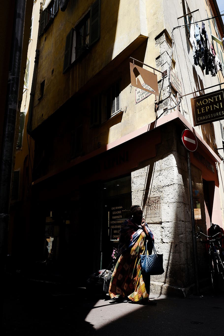 woman waking near corridor, sunlight, shadow, sign, person, building HD wallpaper