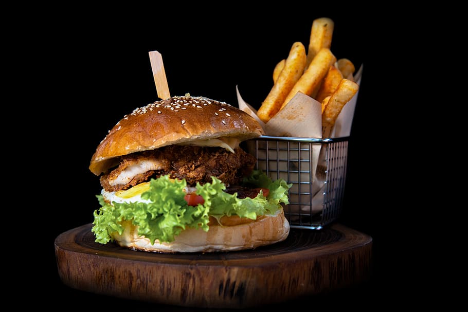hamburger by french fries on board, food, bread, bun, table, furniture