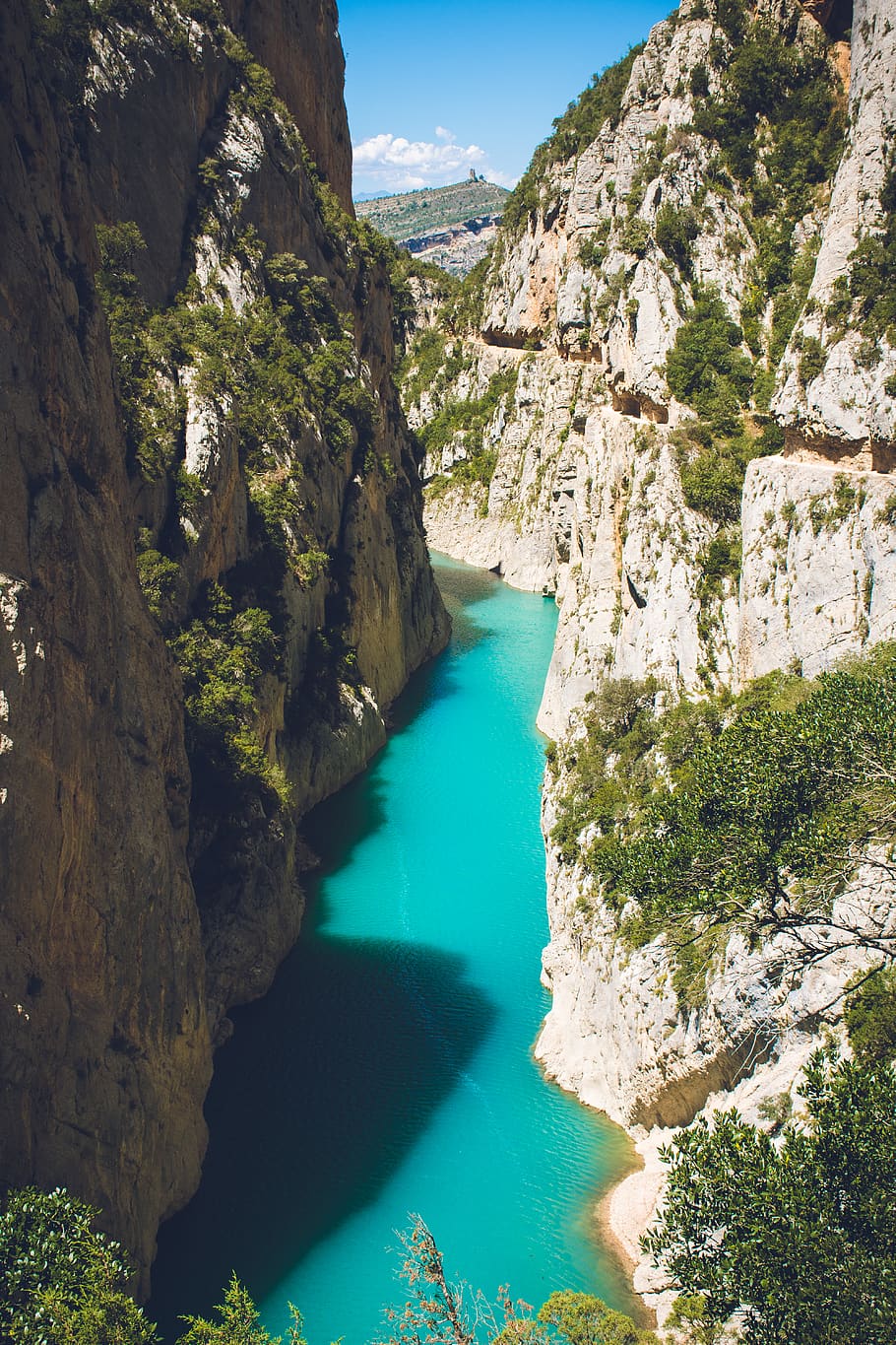 Body of Water in Between of Rock Formation Under Blue Sky at Daytime HD wallpaper