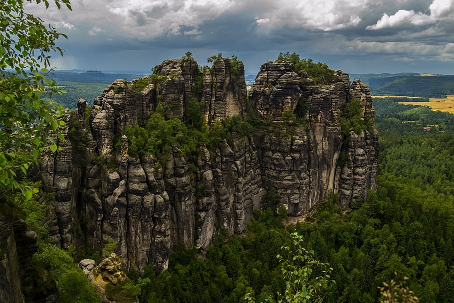 Rock Formation Surrounded by Green Trees during Humid Weather HD wallpaper