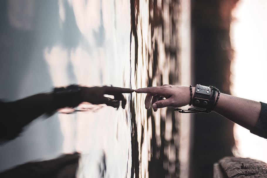 selective focus photography of person's touching body of water HD wallpaper