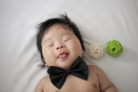 baby lying on bed, human, newborn, person, face, finger, cushion HD wallpaper