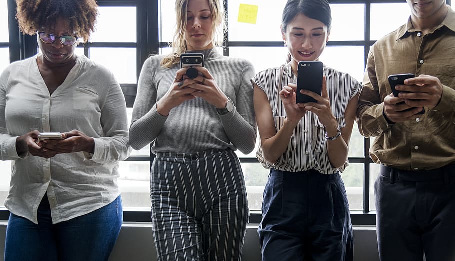 Three Women Standing Near Man Holding Smartphones, casual, cellphone HD wallpaper