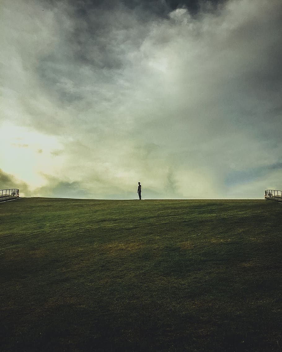 man, alone, field, calm, solitary, dramtic sky, clouds, green, HD wallpaper