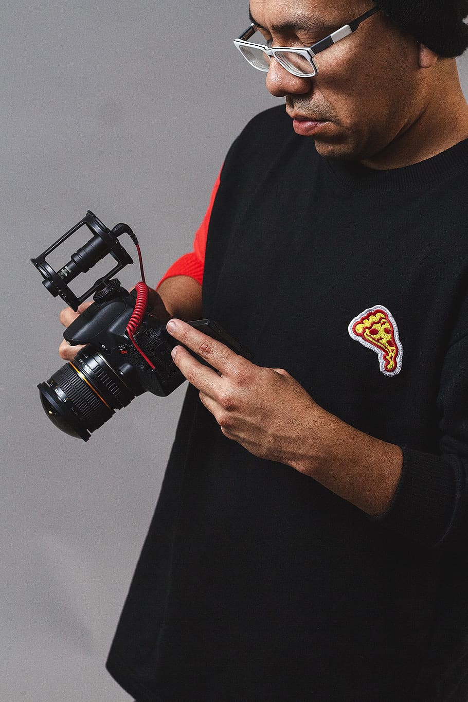 man holding DSLR camera, one person, indoors, men, glasses, front view HD wallpaper