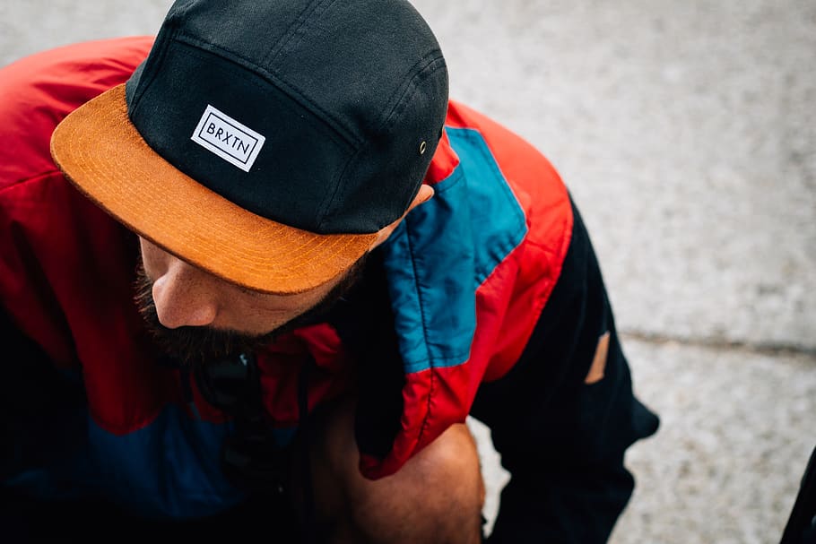 man wearing black and orange Baxin cap looking down, hat, clothing, HD wallpaper