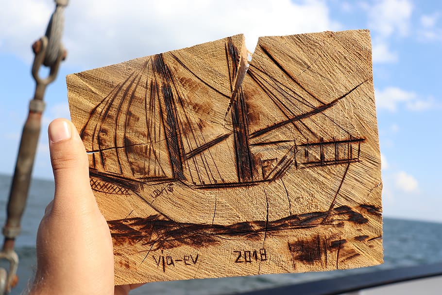 ship, woodcut, carve, sea, sail, human hand, one person, sky
