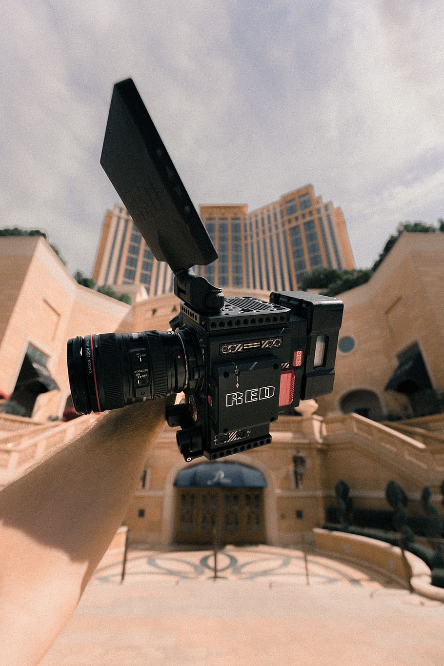 person holding black and grey camcorder under white sky at daytime HD wallpaper