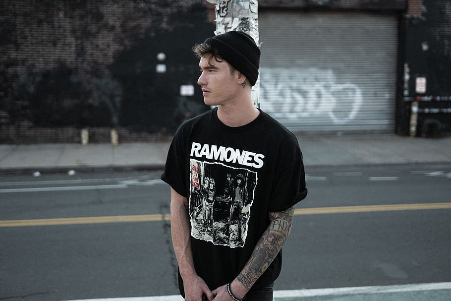 man standing on street wearing black Ramones graphic crew-neck t-shirt and black knit cap during daytime, HD wallpaper