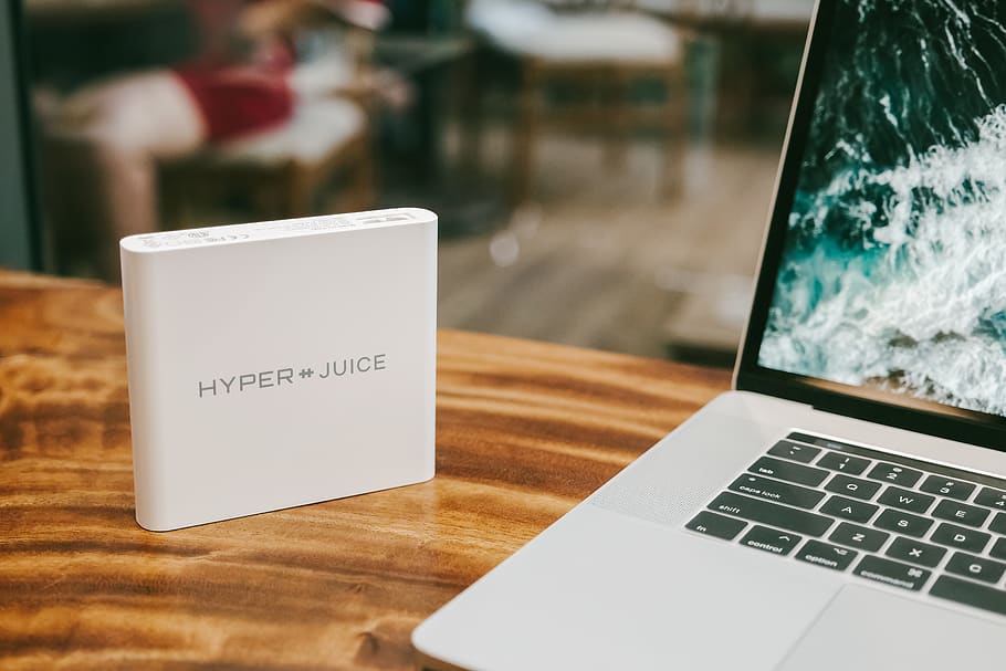 white Hyper Juice beside MacBook Pro, communication, table, wireless technology HD wallpaper