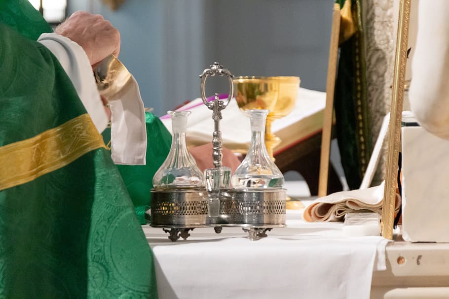priest wiping chalice, human, person, glass, goblet, wine, bishop
