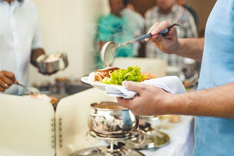 Selective Focus Photography Of Person Holding White Plate And Soup Ladle
