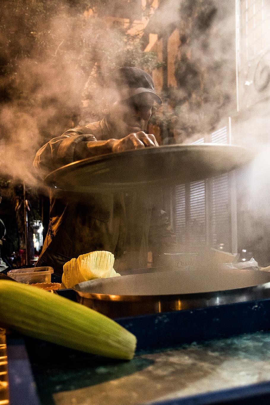 Person Cooking Corn in a Commercial Griddle, close-up, cooking pot