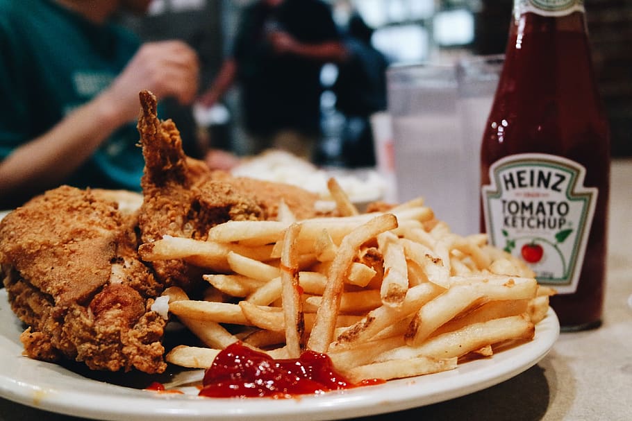 fried chicken and fries on plate beside Heinz Tomato ketchup