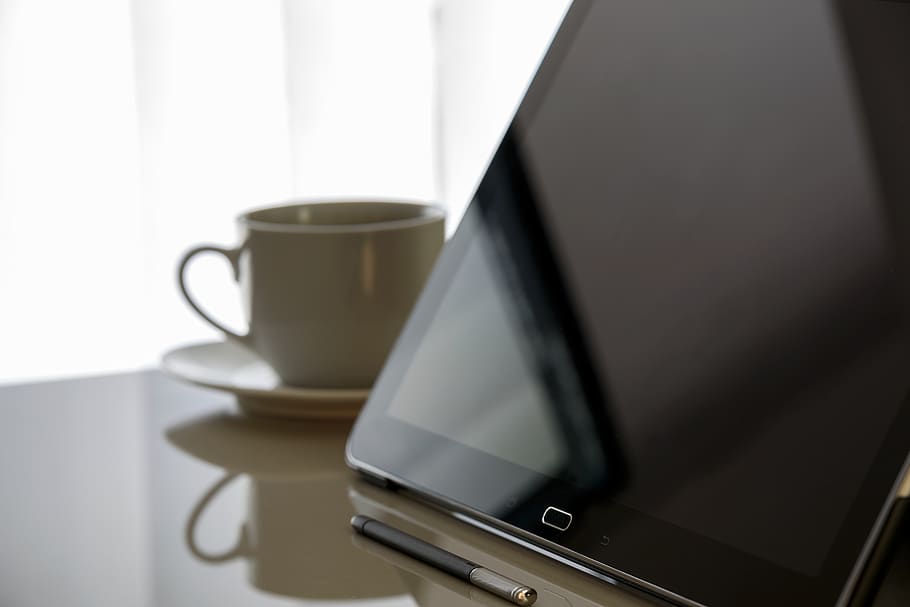 Black Tablet Computer Beside Teacup With Saucer on Table, device HD wallpaper